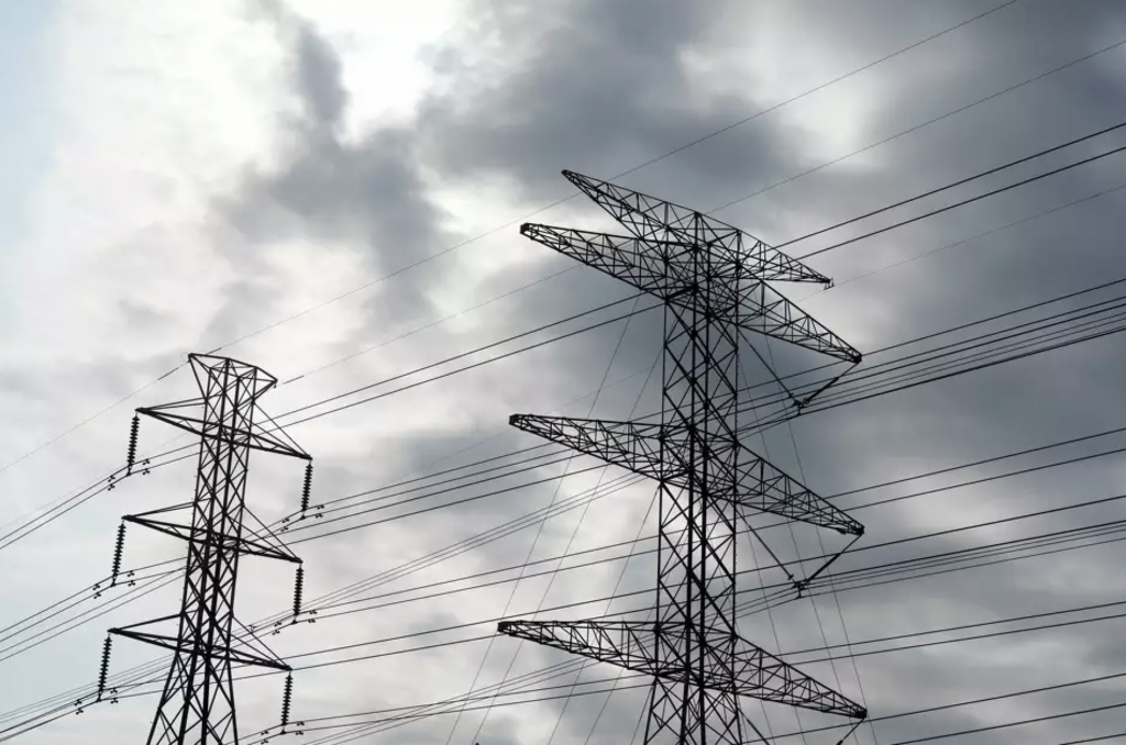 Transmission towers under a cloudy sky