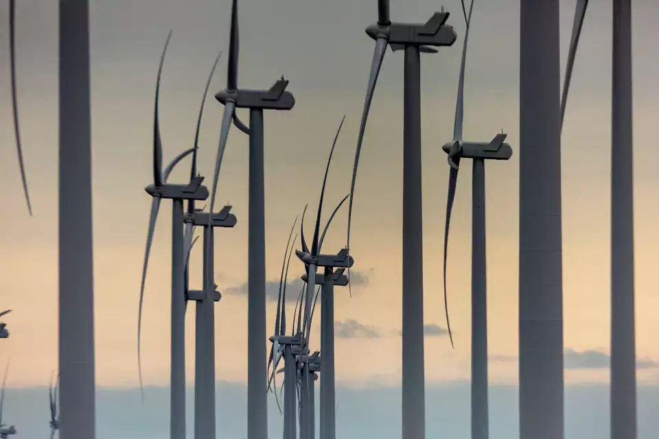 Wind turbines against a hazy sky