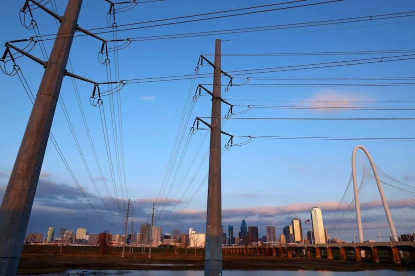 Power lines in front of the Dallas skyline and the Margaret Hunt Hill Bridge
